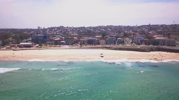 Side panning over Maroubra Beach Sydney coastline with cityscape in the background