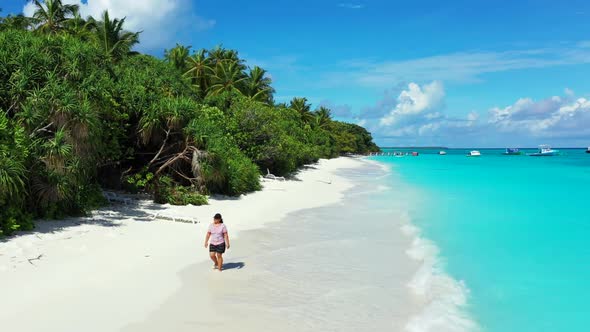 Woman enjoys life on tropical sea view beach voyage by blue sea with white sand background of the Ma