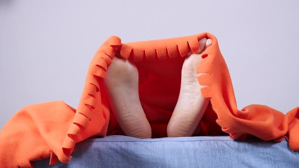 Human Feet Under Blanket