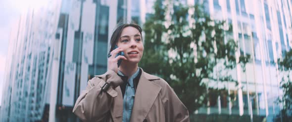 Woman stands while on a call