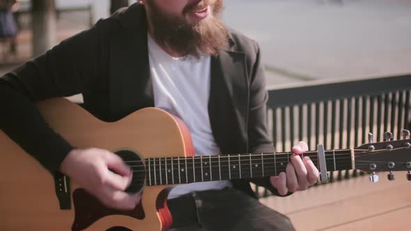 Street Musician Playing Guitar and Singing