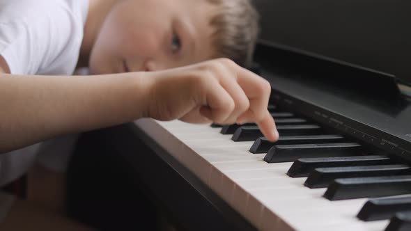 Child was tired in the lesson and lay down on the keys of the instrument