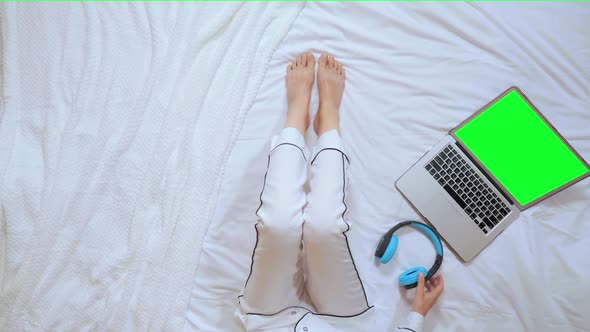 Above View Female Using Computer and Headphones in Apartment