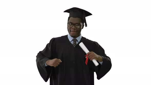 Excited African American Male Student in Graduation Robe Dancing with His Diploma Moving Towards