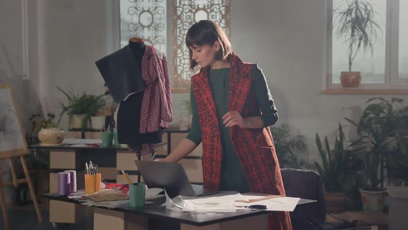 Young Girl Fashion Designer Working In Studio