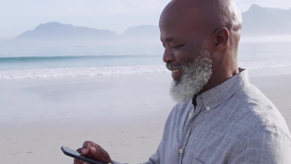 Mature man enjoying time outside by the sea