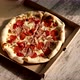 Delivery pizza box. Chopped hot pizza in a cardboard box. Pizza with meat and cheese. - VideoHive Item for Sale
