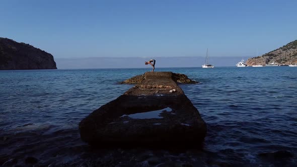 Woman doing yoga near sea