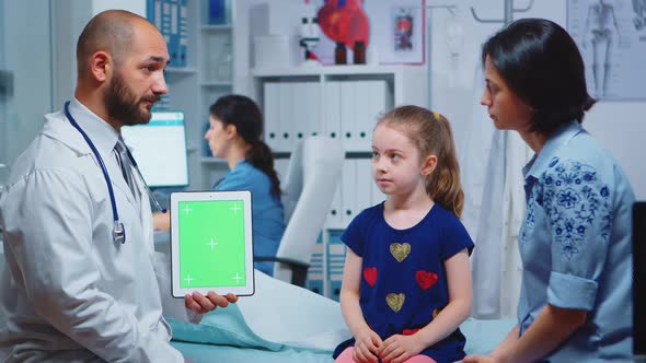 Doctor and Patients Looking at Green Screen Tablet