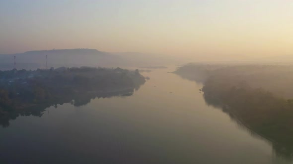 Aerial view of Mekong River with green mountain hill and mist fog. Nature landscape background