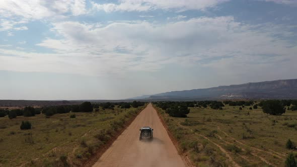 Vehicle Off-Roading Passing Through desert road In Escalante National Park In Utah. Aerial Wide Shot