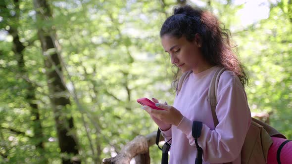 Woman Hiker is Using Cell Phone for Navigating Looking for Information in Internet