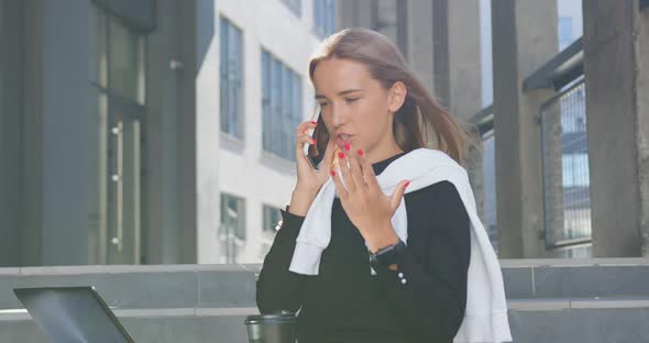 Girl Sitting on Building's Stairs and Has Hard Business Conversation with Worker