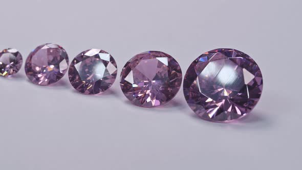 Amethyst Diamonds In A Row On White Background.