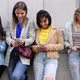 Multiethnic Group of Beautiful Young Female Friends Standing Against a Wall Using Mobile Smartphones - VideoHive Item for Sale