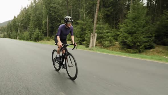 Woman cycling. Cyclist riding bicycle. Triathlete hard training