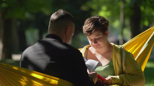 Couple reading in hammock