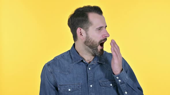 Sleepy Beard Young Man Yawning, Yellow Background