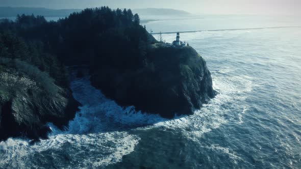 Dreamy Blue Aerial Of Coastal Lighthouse At Cape Disappointment