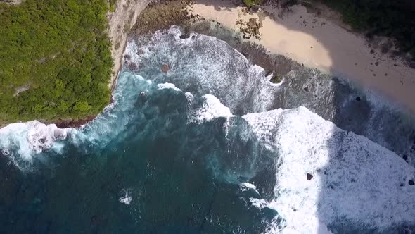 Calmer aerial view flight slowly circle drone shot very high over big waves Untouched nature  beach