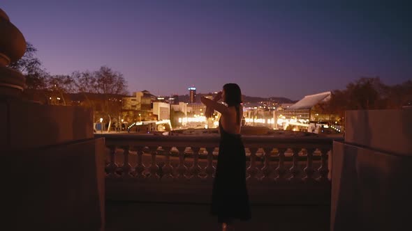 Young Professional Ballerina in Black Dress Is Dancing Outdoors