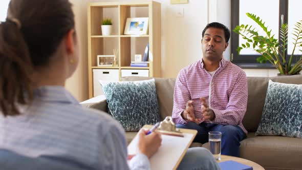Man and Psychologist at Psychotherapy Session
