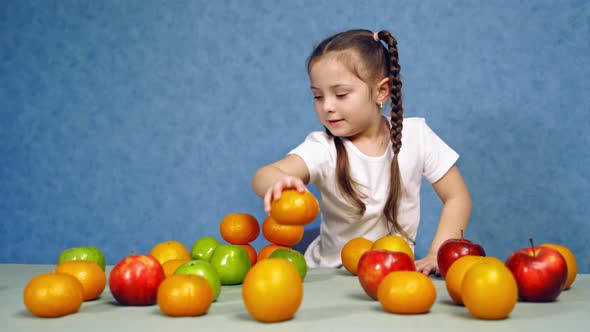 Cute small girl with fruit at home