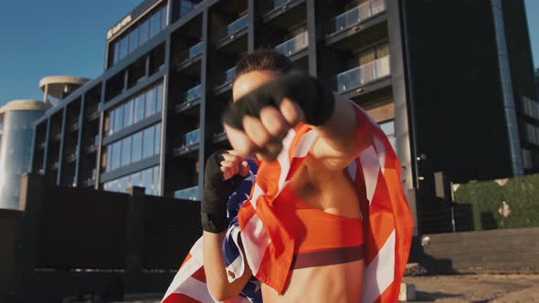 Young Female in Sportswear Wrapped in Flag of USA