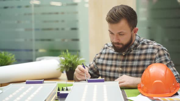 Caucasian Architect Working on House Model Scale Planning Building Project