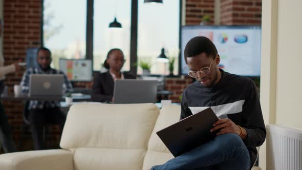 Portrait of Company Employee Working on Laptop Computer