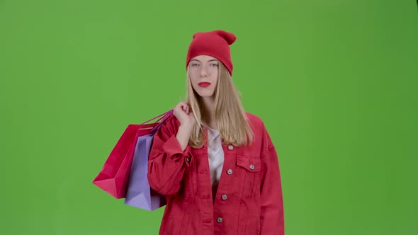 Girl Comes with Bags in His Hands. Green Screen