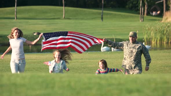 Patriotic Family Running with Huge USA Background Outdoor.