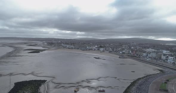 Aerial push in over a cloudy Morecambe bay, Lancashire