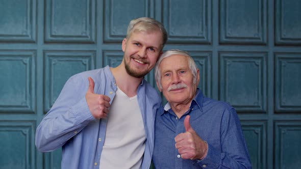 Happy Different Male Generations Family of Senior Father and Adult Son or Grandson Showing Thumbs Up