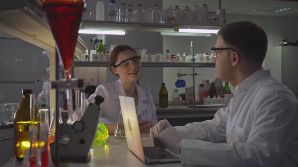 Two Happy Doctors Talking in Laboratory