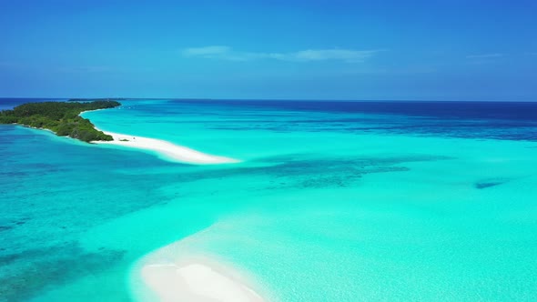 Natural aerial tourism shot of a paradise sunny white sand beach and aqua blue ocean background