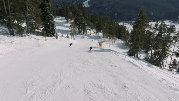 Aerial View of a Ski Resort with People Snowboarding and Skiing From a Hill