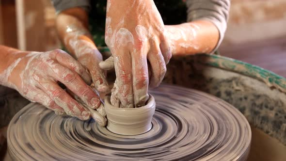 Female potter assisting a girl