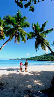 Couple Man and Woman on Vacation Seychelles Mahe Seychelles Tropical Beach with Palm Trees and a