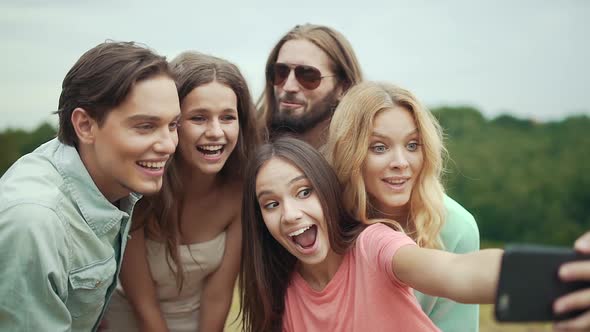 Friends Having Fun And Taking Photos In Nature