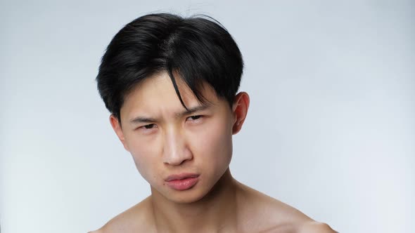 Open Sight Eyes Handsome Asian Man Looking at Camera Closeup White Background 