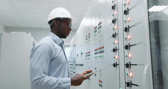 Portrait of an Engineer in a Hard Hat Holding a Tablet