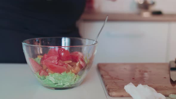 Shot of Olive Oil Being Poured Out on Vegetable Salad