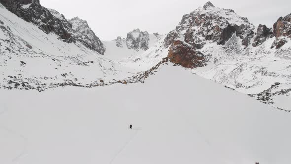 Aerial Shot of Man Ski Touring in Winter Glacier Mountains