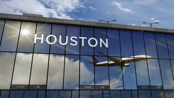 Airplane landing at Houston Texas mirrored in airport terminal