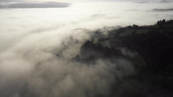 Aerial view of morning fog over forest in Umbria, Italy