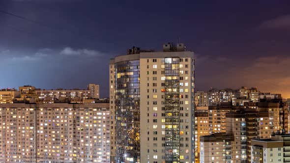 City Buildings at Night Windows Flashing with Illumination of Light