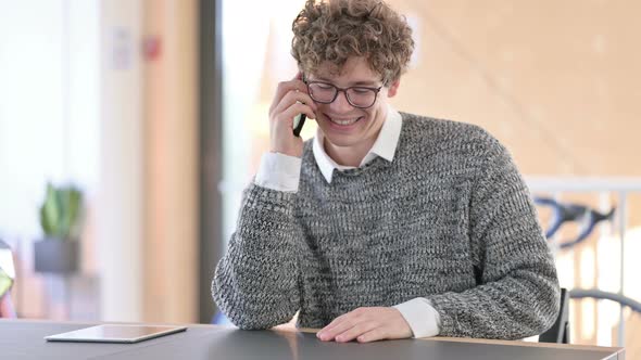 Cheerful Young Man Talking on Smartphone