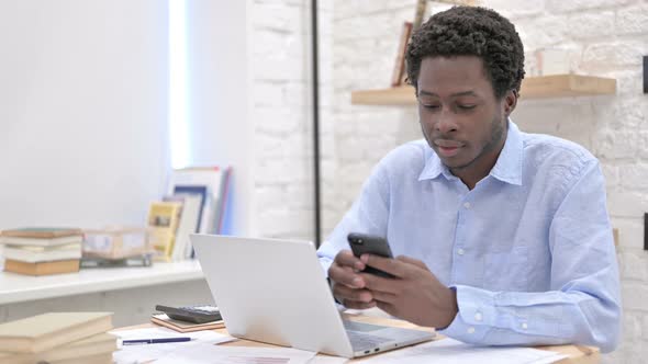 African Guy Using His Cellphone