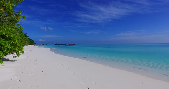 Natural birds eye tourism shot of a sunshine white sandy paradise beach and aqua turquoise water bac